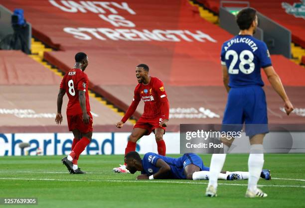 Naby Keita of Liverpool celebrates with teammate Georginio Wijnaldum after scoring his team's first goal during the Premier League match between...