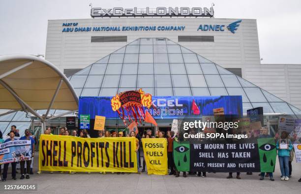 Protesters hold anti-Shell banners and placards during the demonstration. Climate activists gathered outside the Excel Centre as Shell held its...