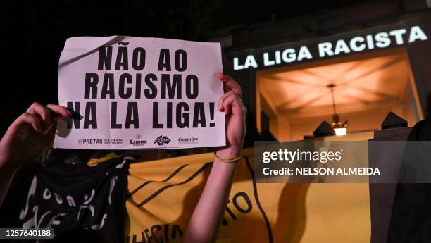 Demonstrator holds a sign reading "No to racism in La Liga" during a protest against racism and in support of Real Madrid's player Vinicius Junior...