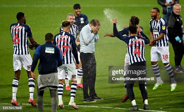 Slaven Bilić , head coach of West Bromwich is showered with champaign after the Sky Bet Championship match between West Bromwich Albion and Queens...