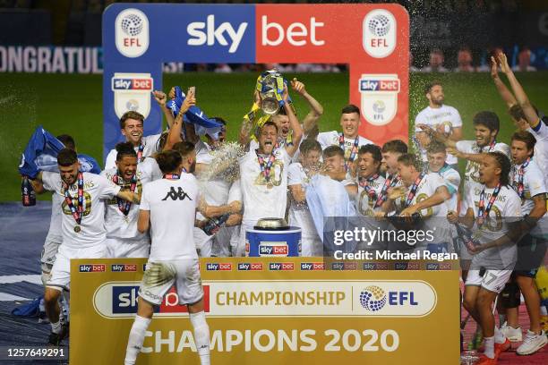 Liam Cooper of Leeds United lifts the trophy in celebration with team mates after the Sky Bet Championship match between Leeds United and Charlton...