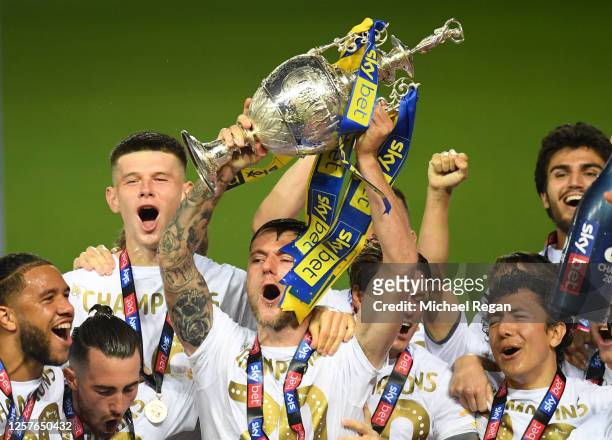 Liam Cooper of Leeds United lifts the trophy in celebration with team mates after the Sky Bet Championship match between Leeds United and Charlton...