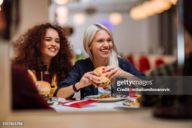 super ready to dig in - woman eating burger stock pictures, royalty-free photos & images