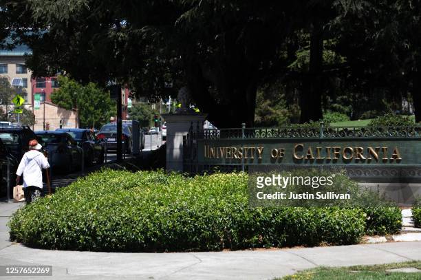 Pedestrian walks by a sign in front of the U.C. Berkeley campus on July 22, 2020 in Berkeley, California. U.C. Berkeley announced plans on Tuesday to...