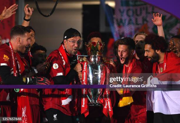 Jurgen Klopp, Manager of Liverpool and Adam Lallana of Liverpool lift The Premier League trophy following the Premier League match between Liverpool...