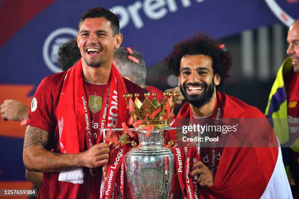 Dejan Lovren and Mohamed Salah of Liverpool celebrate with The Premier League trophy following the Premier League match between Liverpool FC and...