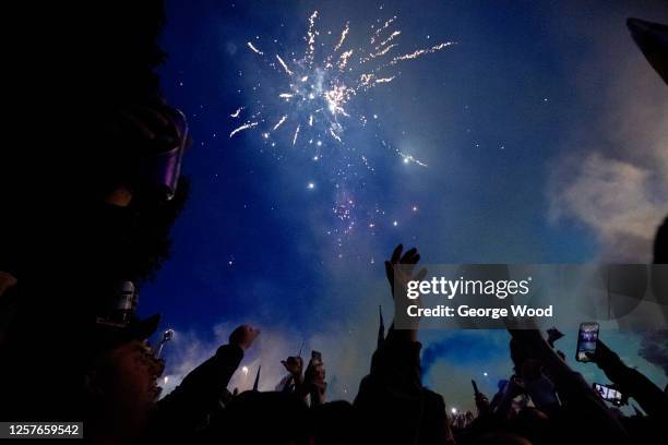 Leeds United supporters celebrate as the Leeds United players lift the Sky Bet Championship trophy outside of the stadium in front of their fans...