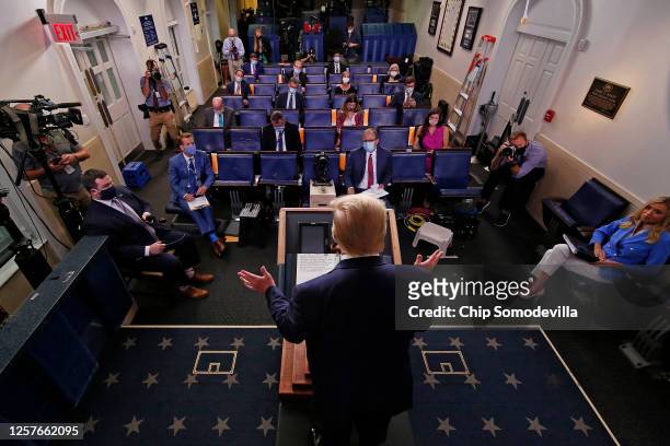 President Donald Trump talks to journalists during a news conference about his administration's response to the ongoing global coronavirus pandemic...