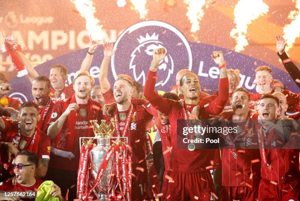 Liverpool players celebrate with The Premier League trophy following the Premier League match between Liverpool FC and Chelsea FC at Anfield on July...