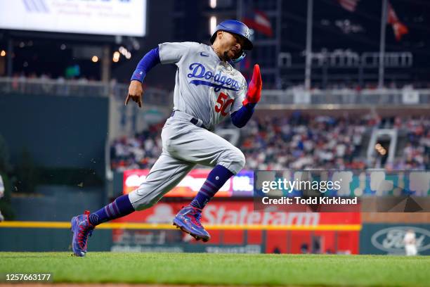 Mookie Betts of the Los Angeles Dodgers rounds third on his way to score in the seventh inning against the Atlanta Braves at Truist Park on May 23,...