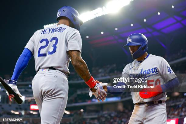 Mookie Betts of the Los Angeles Dodgers celebrates scoring with Jason Heyward in the seventh inning against the Atlanta Braves at Truist Park on May...