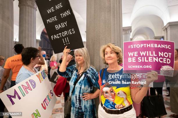 Abortion-rights activists wait for state lawmakers to arrive before a Senate vote on a ban on abortion after six weeks of pregnancy at the South...