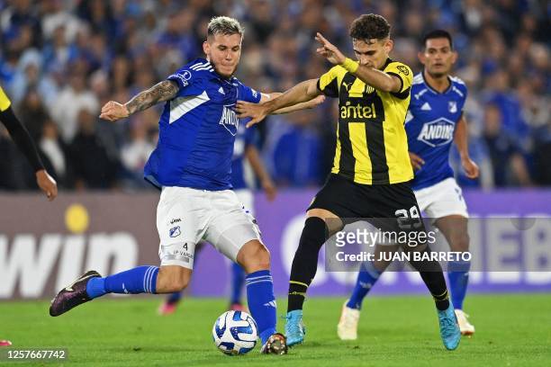 Millonarios' Costa Rican defender Juan Pablo Vargas and Penarol's forward Maximo Alonso vie for the ball during the Copa Sudamericana group stage...