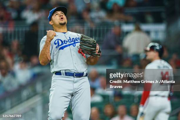 Brusdar Graterol of the Los Angeles Dodgers celebrates after recording the final out of the seventh inning against the Atlanta Braves at Truist Park...