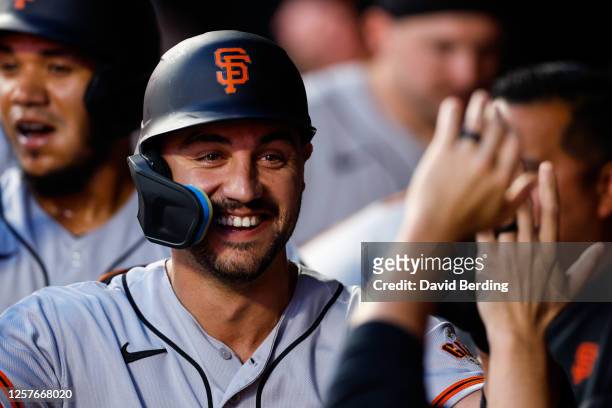 Michael Conforto of the San Francisco Giants celebrates his two-run home run with teammates in the dugout in the seventh inning against the Minnesota...
