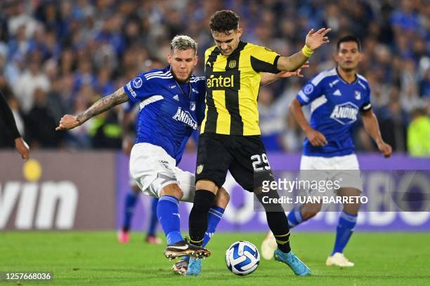 Millonarios' Costa Rican defender Juan Pablo Vargas and Penarol's forward Maximo Alonso vie for the ball during the Copa Sudamericana group stage...