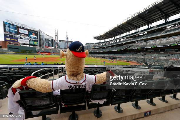 Blooper, mascot of the Atlanta Braves, sits in the empty stands to watch the exhibition game between the Atlanta Braves and the Miami Marlins at...