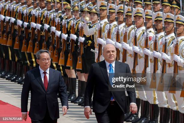 Russian Prime Minister Mikhail Mishustin and Chinese Premier Li Qiang attend a welcoming ceremony on May 24, 2023 in Beijing, China. The two were...