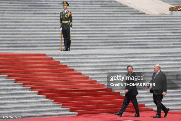 Russian Prime Minister Mikhail Mishustin and Chinese Premier Li Qiang attend a welcoming ceremony in Beijing on May 24, 2023.