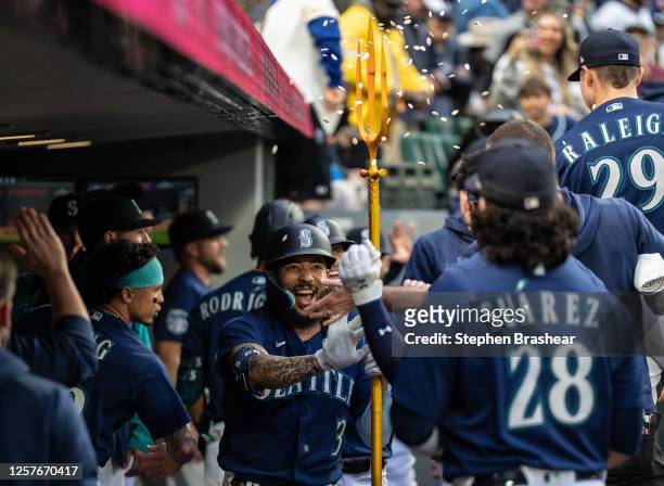Crawford of the Seattle Mariners celebrates in the dugout after hitting a two-run home run off starting pitcher Luis Medina of the Oakland Athletics...