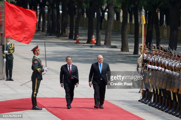 Russian Prime Minister Mikhail Mishustin and Chinese Premier Li Qiang attend a welcoming ceremony on May 24, 2023 in Beijing, China. The two were...