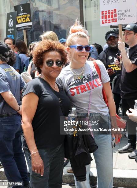 Wanda Sykes and Busy Philipps are seen attending the Writers Guild of America strike outside the NBC Building on May 23, 2023 in New York City.