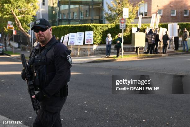 Policemen are seen outside Admirality House where a small group of protesters gathered during the meeting of India's Prime Minister Narendra Modi and...