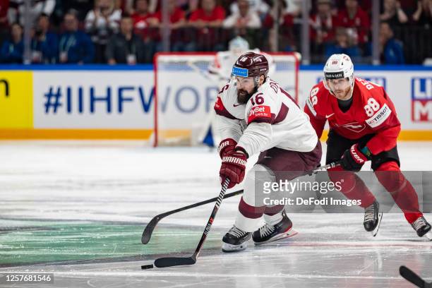 Kaspars Daugavins of Latvia controll the puck during the 2023 IIHF Ice Hockey World Championship Finland - Latvia game between Switzerland and Latvia...
