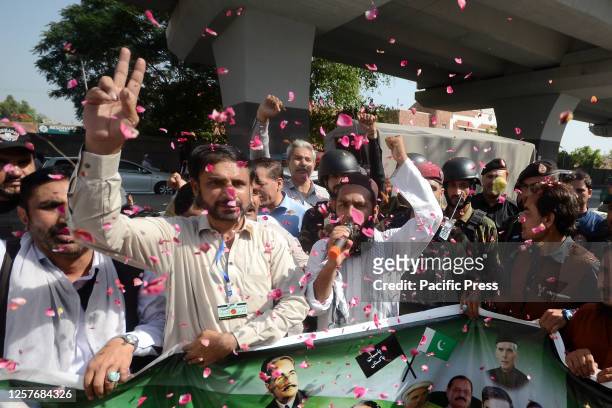 People shout slogans as they attend a rally in support of the Pakistani Army following the violent protests that erupted after the arrest of former...