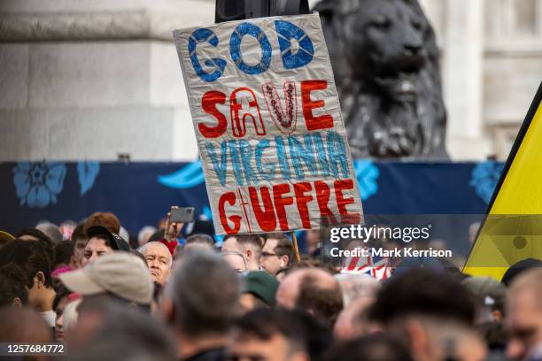 Sign referencing Virginia Giuffre is held aloft in Trafalgar Square adjacent to a protest by anti-monarchy movement Republic during the Coronation of...