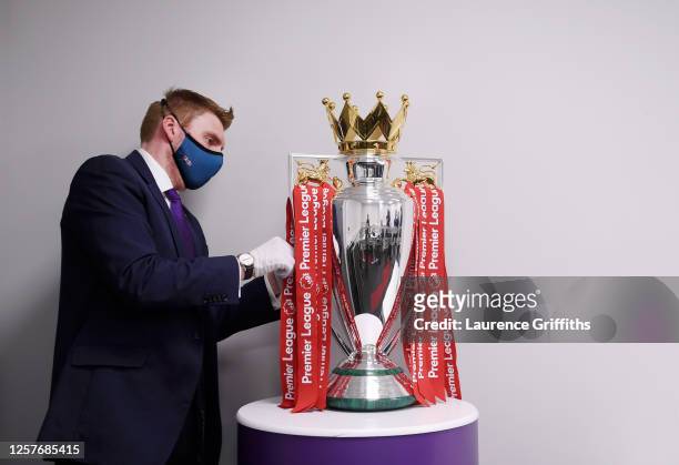 The Premier League Trophy is dressed in Liverpool Red Ribbons ready for the presentation ceremony ahead of the Premier League match between Liverpool...