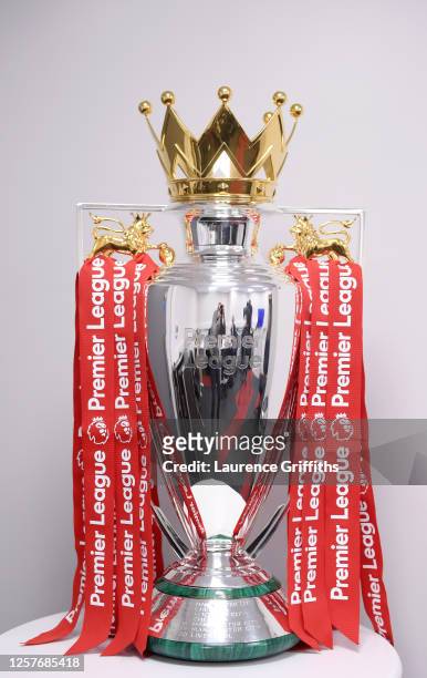 The Premier League Trophy is dressed in Liverpool Red Ribbons ready for the presentation ceremony ahead of the Premier League match between Liverpool...