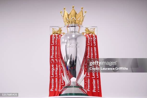 The Premier League Trophy is dressed in Liverpool Red Ribbons ready for the presentation ceremony ahead of the Premier League match between Liverpool...