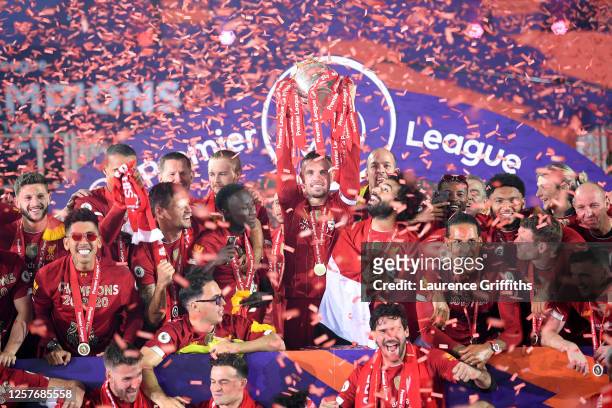 Jordan Henderson of Liverpool holds the Premier League Trophy aloft along side Mohamed Salah as they celebrate winning the League during the...