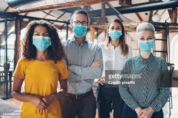 group of business persons with face masks - business meeting with masks stock pictures, royalty-free photos & images