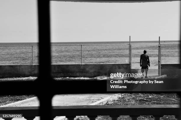 Man Looking Out At The Beach High-Res Stock Photo