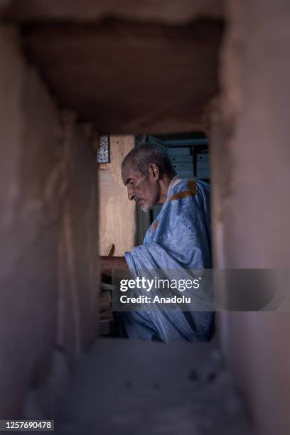 Abdullah Habott, the book preserver, observes ancient handwriting manuscripts in Chinguetti, Mauritania on May 10, 2023. The towns Chinguetti, that...