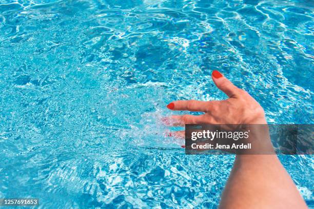 woman's hand swimming pool, relaxing vacation staycation - swimming pool and hand stock-fotos und bilder