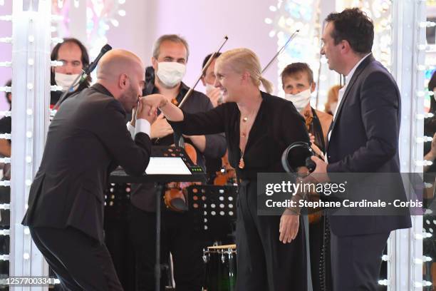 Italian fashion designer Maria Grazia Chiuri for Christian Dior is congratulated by musicians and Italian singer Giuliano Sangiorgi at the end of the...