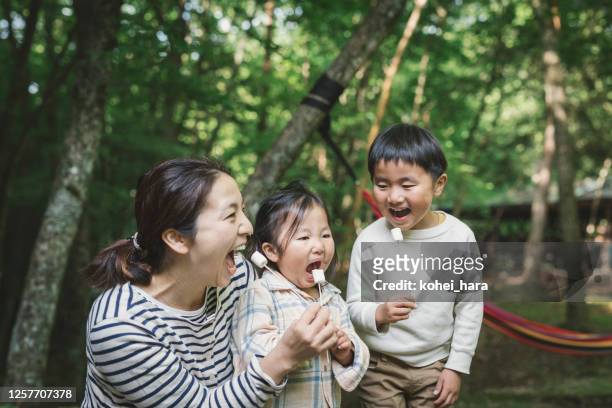 family eating marshmallow at camping. - japan mom and son stock pictures, royalty-free photos & images