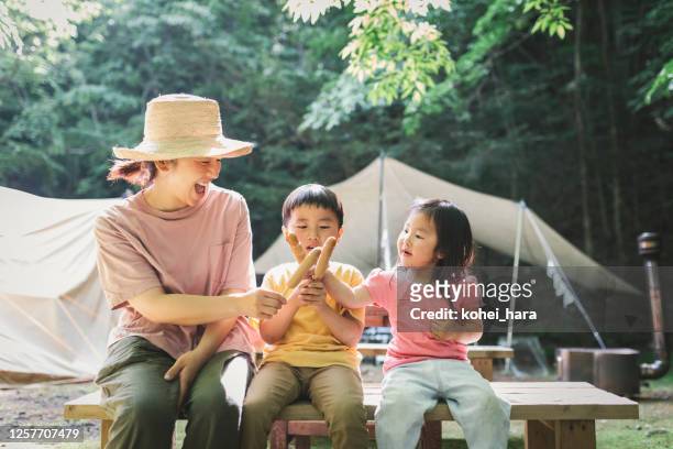 family having breakfast in the mountain - asian family camping stock pictures, royalty-free photos & images