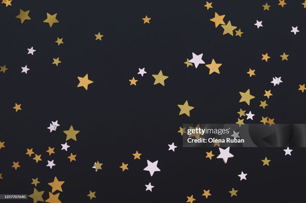 Bright golden stars on black background