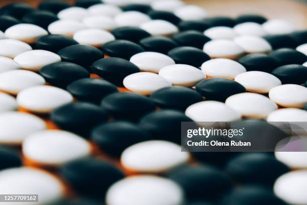 wooden board for playing go with stones as background - go brettspiel stock-fotos und bilder