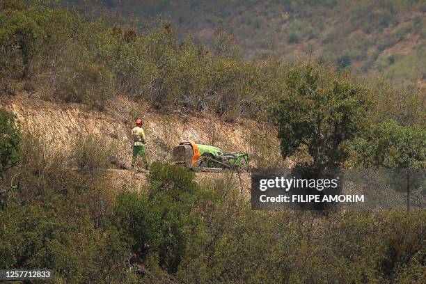Staff member pilots a machine as Portuguese Judicial Police members work in the Arade dam area, in Silves, on 24 May, 2023 on the second day of a new...