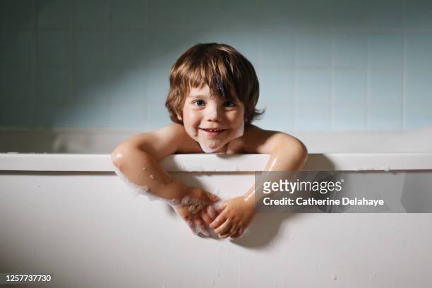 a little boy taking a bath - taking a bath stock pictures, royalty-free photos & images