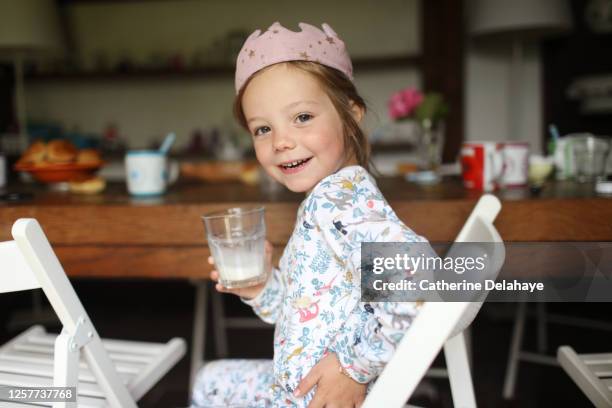 a 5 year old girl drinking a glass of milk - french_crown stock pictures, royalty-free photos & images