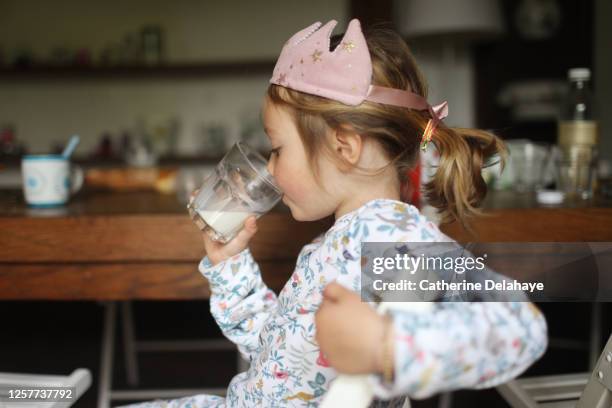 a 5 year old girl drinking a glass of milk - milk crown stock pictures, royalty-free photos & images