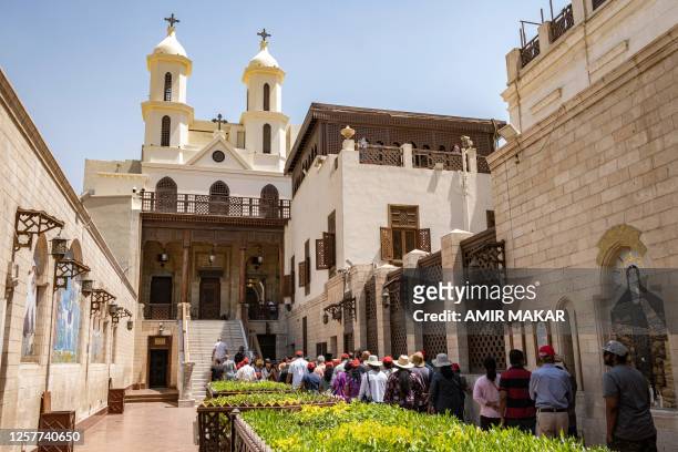 In this picture taken on May 10 South Asian tourists queue in the courtyard to enter the historic Hanging Church, which was built in the seventh...