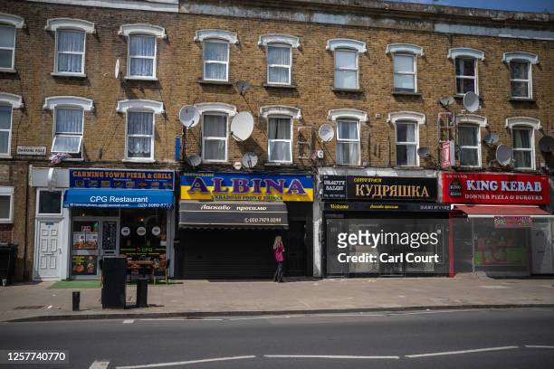 Woman chats on her phone outside a Ukrainian restaurant in Canning Town on May 24, 2023 in London, England. Britain's Office for National Statistics...
