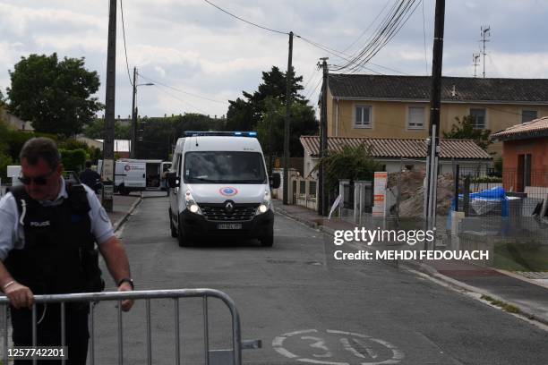 Policeman moves a barrier to enable a police vehicle to move on a street in Merignac, on the outskirts of Bordeaux, south-western France on May 24...